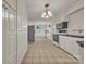 Spacious kitchen with tiled floor, bright white cabinets, black countertops, and modern appliances at 8974, 8972 & 8970 Nc 90 E Hwy, Stony Point, NC 28678