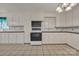 Bright kitchen with tile flooring, white cabinets, black countertops, and modern appliances at 8974, 8972 & 8970 Nc 90 E Hwy, Stony Point, NC 28678