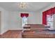 Spacious room showcases a grand piano, polished hardwood floors, and natural light pouring through the windows at 8974, 8972 & 8970 Nc 90 E Hwy, Stony Point, NC 28678