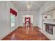 An open-concept living room with hardwood floors, fireplace, and a view into the room with the piano at 8974, 8972 & 8970 Nc 90 E Hwy, Stony Point, NC 28678