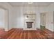 A bright living room with hardwood floors, a decorative fireplace, and an open doorway at 8974, 8972 & 8970 Nc 90 E Hwy, Stony Point, NC 28678