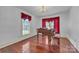 Elegant living room features a grand piano, hardwood floors, and natural light from large windows at 8974, 8972 & 8970 Nc 90 E Hwy, Stony Point, NC 28678