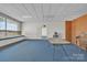 Spacious meeting room with blue carpet, white walls, and natural light at 8974, 8972 & 8970 Nc 90 E Hwy, Stony Point, NC 28678