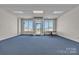 Spacious office space with bright windows, blue carpet, and modern design at 8974, 8972 & 8970 Nc 90 E Hwy, Stony Point, NC 28678
