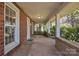 Inviting front porch with brick siding, concrete floor, and white pillars at 8974, 8972 & 8970 Nc 90 E Hwy, Stony Point, NC 28678