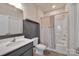 Well-lit bathroom featuring a modern vanity, tub/shower combo with stylish curtain at 9032 Cornflower Dr, Harrisburg, NC 28075