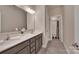 This bathroom offers double sinks, grey cabinets and a shower/tub combo at 9032 Cornflower Dr, Harrisburg, NC 28075