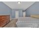 Spacious bedroom with neutral carpet and a classic wood dresser at 9032 Cornflower Dr, Harrisburg, NC 28075