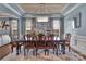 Formal dining room with a large wooden table, chandelier, and ample seating at 9032 Cornflower Dr, Harrisburg, NC 28075