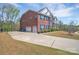 Spacious driveway leading to a three-car garage with a beautiful lawn at 9032 Cornflower Dr, Harrisburg, NC 28075