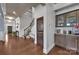Welcoming foyer featuring hardwood floors, staircase, and built-in bar area at 9032 Cornflower Dr, Harrisburg, NC 28075