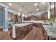 Kitchen featuring dark brown cabinets, stainless steel appliances, and a large kitchen island at 9032 Cornflower Dr, Harrisburg, NC 28075