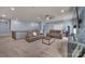 Spacious living room with a large TV, comfortable seating, and natural light from nearby windows at 9032 Cornflower Dr, Harrisburg, NC 28075