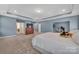 Spacious main bedroom with tray ceilings, ensuite bathroom, and home gym at 9032 Cornflower Dr, Harrisburg, NC 28075