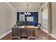 Comfortable office space featuring natural light and a dark blue accent wall at 9032 Cornflower Dr, Harrisburg, NC 28075
