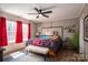 Bright bedroom with a ceiling fan, large windows, and a comfortable-looking bed at 980 Lakeland Ave, Lincolnton, NC 28092