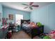 Bright bedroom with blue walls, ceiling fan, and desk at 980 Lakeland Ave, Lincolnton, NC 28092