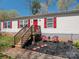 Home exterior featuring well-kept yard and red shutters at 980 Lakeland Ave, Lincolnton, NC 28092