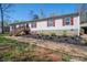 Charming home exterior with wood stairs, red shutters, and a well-maintained lawn at 980 Lakeland Ave, Lincolnton, NC 28092
