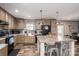 Modern kitchen featuring wood cabinets, brick backsplash, black appliances, and a large kitchen island at 980 Lakeland Ave, Lincolnton, NC 28092
