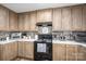 Well-equipped kitchen with ample wooden cabinetry, modern appliances and brick backsplash at 980 Lakeland Ave, Lincolnton, NC 28092
