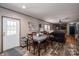 Open concept: Dining area leading to a living room with comfortable leather seating at 980 Lakeland Ave, Lincolnton, NC 28092