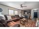 Cozy living room featuring a large leather sofa, ceiling fan and a flat-screen TV at 980 Lakeland Ave, Lincolnton, NC 28092