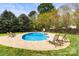 Secluded backyard with inviting pool, comfortable seating, and lush landscaping for relaxing privacy at 10609 Washam Potts Rd, Cornelius, NC 28031