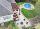 Aerial view of backyard with a patio, pergola, fire pit, and kidney-shaped pool with ample green space at 10609 Washam Potts Rd, Cornelius, NC 28031