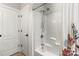Clean bathroom featuring a shower-tub combination with white tile, a shower caddy, and modern fixtures at 10609 Washam Potts Rd, Cornelius, NC 28031