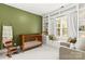 Cozy Bedroom with wooden crib, rocking chair, window seat, and built-in bookshelves for ample storage at 10609 Washam Potts Rd, Cornelius, NC 28031