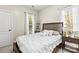 Bright bedroom with a large bed, natural light from two windows, and classic decor at 10609 Washam Potts Rd, Cornelius, NC 28031