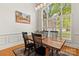 Spacious dining room showcasing a rustic wood table, a large window and a light fixture at 10609 Washam Potts Rd, Cornelius, NC 28031