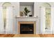 Close up of the fireplace and mantle, complete with hearth, windows, and decor at 10609 Washam Potts Rd, Cornelius, NC 28031