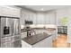 Bright kitchen with stainless steel appliances, granite countertops, and ample cabinetry at 10609 Washam Potts Rd, Cornelius, NC 28031