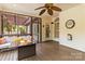 Covered porch with cushioned seating around a fire pit and an outdoor ceiling fan at 10609 Washam Potts Rd, Cornelius, NC 28031