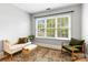 Cozy sitting room with large window, comfortable seating, and a stylish rug at 10609 Washam Potts Rd, Cornelius, NC 28031