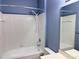 A bathroom includes a white tiled shower and tub with a vanity and mirror at 10720 Hill Point Ct, Charlotte, NC 28262