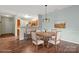 Bright dining room features a wood table, elegant lighting, and an open layout leading into the kitchen at 10720 Hill Point Ct, Charlotte, NC 28262