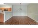 Well-lit dining area with stylish lighting fixture, flowing into the adjacent kitchen space at 10720 Hill Point Ct, Charlotte, NC 28262