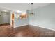 Open-concept dining area with modern light fixture, seamlessly connected to the kitchen at 10720 Hill Point Ct, Charlotte, NC 28262