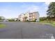 Spacious parking lot and residential condo building showcasing architectural details and landscaping at 10720 Hill Point Ct, Charlotte, NC 28262