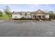 An exterior shot of the clubhouse with ample parking at 10720 Hill Point Ct, Charlotte, NC 28262
