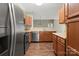 Well-equipped kitchen featuring stainless steel appliances, wooden cabinets and view of dining area at 10720 Hill Point Ct, Charlotte, NC 28262