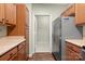 A kitchen showcases wood cabinets, a light countertop, a stainless steel refrigerator and wood floors at 10720 Hill Point Ct, Charlotte, NC 28262