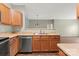 Modern kitchen with stainless steel appliances and wood cabinets, open to the living area at 10720 Hill Point Ct, Charlotte, NC 28262