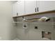 A laundry room features white cabinets, shelving, and hookups for a washer and dryer at 10720 Hill Point Ct, Charlotte, NC 28262