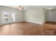 Inviting living room with wood floors and natural light, adjacent to the entryway at 10720 Hill Point Ct, Charlotte, NC 28262