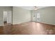 Bright living room with hardwood floors and door leading to a balcony offering indoor-outdoor living at 10720 Hill Point Ct, Charlotte, NC 28262