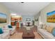 Inviting living room with sofas, wood floors, and an open floor plan flowing to the kitchen and dining area at 10720 Hill Point Ct, Charlotte, NC 28262